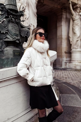 a lady in a white down coat and a black skirt